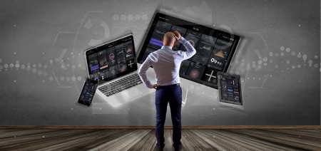 View of Businessman in front of a wall with Devices connected to a cloud multimedia network 3d renderingの写真素材