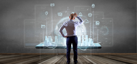View of Businessman in front of a wall with Smart city user interface with icon, stats and data 3d renderingの写真素材