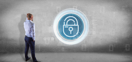 View of Businessman in front of a wall with Security padlock wheel icon with stats and binary code...