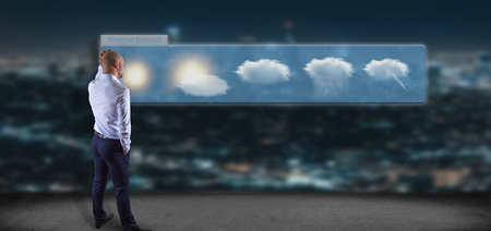View of a Businessman in front of a Weather Forecast widgetの写真素材