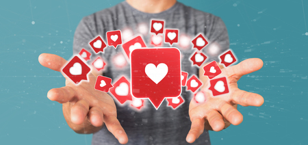 View of a Businessman holding Like notification on a social media 3d renderingの写真素材