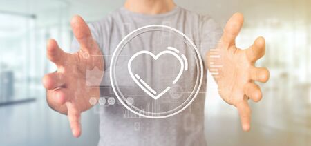 View of a Businessman holding a heart icon surrounded by dataの写真素材