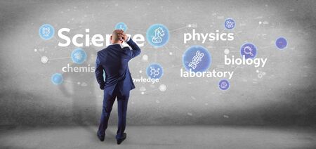 View of a Businessman holding Science icons and title 
