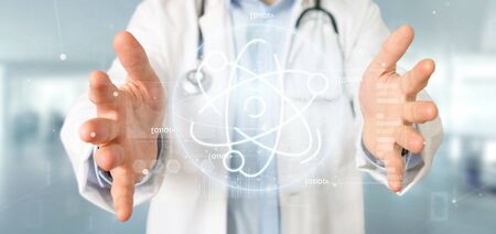 View of a Doctor holding an atom icon surrounded by dataの写真素材