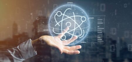 View of a Businessman holding an atom icon surrounded by data