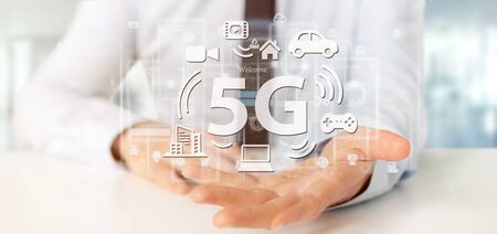View of a Businessman holding a 5G connection with data surrounding - 3d renderingの写真素材