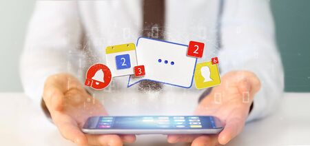 View of a Businessman holding Social network notifications - 3d renderingの写真素材