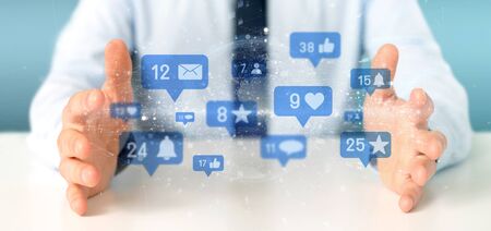 View of a Businessman holding Social network notifications - 3d renderingの写真素材