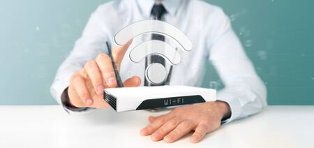View of a Businessman holding a Wifi router and data - 3d renderingの写真素材