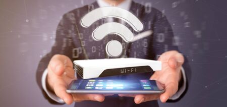View of a Businessman holding a Wifi router and data - 3d renderingの写真素材