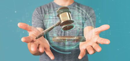 View of a Businessman holding a Justice hammer and data - 3d rendering
