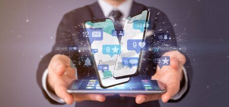 View of a Businessman holding Social network notifications - 3d renderingの写真素材