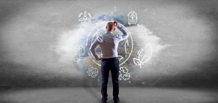 View of a Businessman in front of a World globe surronding by ecology icons and connection 3d renderingの写真素材