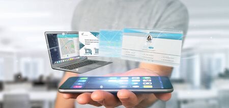 View of a Businessman holding a Website application going out a laptop screen 3d renderingの写真素材