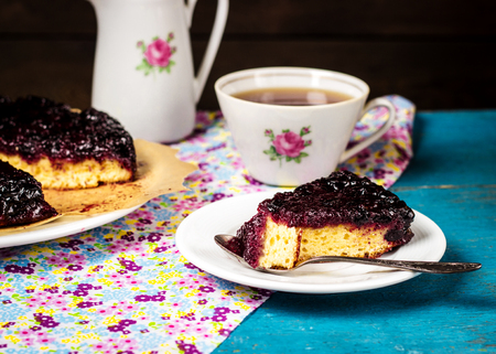 blackcurrant pie and tea on a wooden table, a still life in style a rusticの写真素材