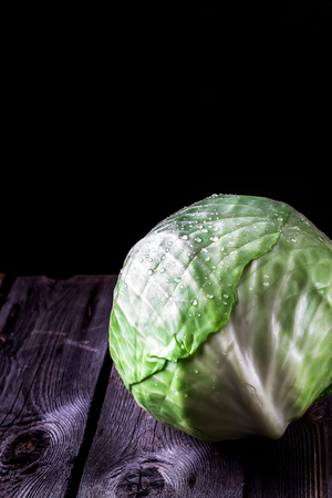 Cabbage on dark wooden background. Style rustic. Selective focus.の写真素材