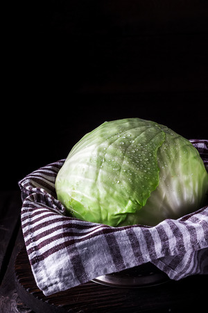 Cabbage on dark wooden background. Style rustic. Selective focus.の写真素材