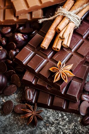 Delicious chocolates and spices on a dark background. Selective focus. Top view.の写真素材
