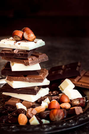 Chocolate / Chocolate bar / chocolate background/chocolate tower and nuts.  Dark  background. Selective focus.の写真素材
