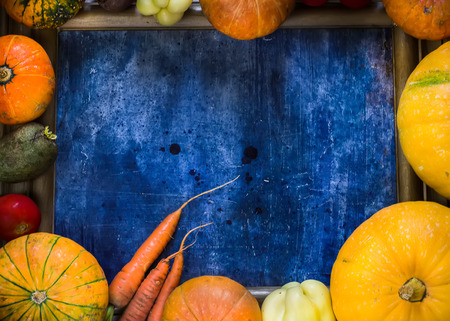 Frame of vegetables on blue background. Harvest, autumn background. Copy space. Selective focus.の写真素材