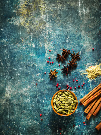 Spices on blue stone background with space for text. Selective focus.