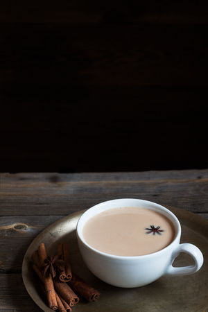Hot beverage in cup and spices. Style rustic. Copy space. Selective focus.の写真素材