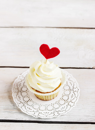 Cupcakes with red hearts for St. Valentines Day.White wooden background.Place for text. Selective focusの写真素材
