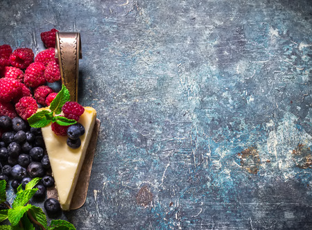 Cheesecake with berries on blue slate background. Selective focus.の写真素材