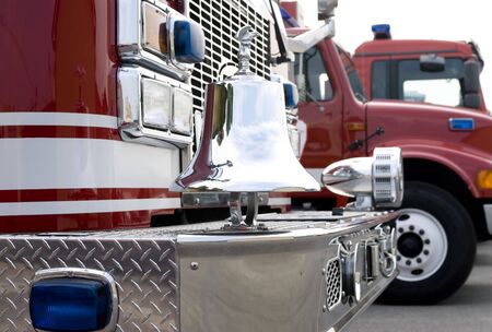 The front of a fire truck with chrome trim and bell