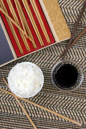 A small bowl of white rice with soy sauceの写真素材