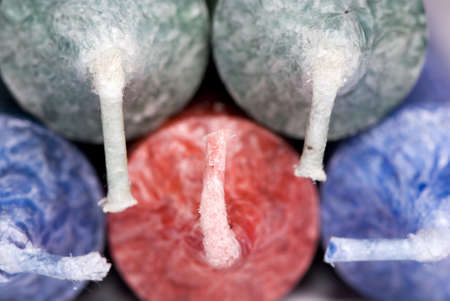 A close up shot of the wicks of colored candles for Christmasの写真素材
