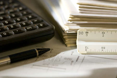 The morning sunlight casts shadows across the drawings on the desktop from the previous day.の写真素材