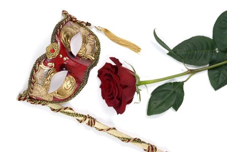 An ornate venetian mask with a single red roseの写真素材