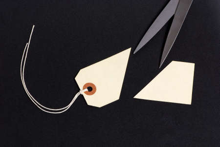 A blank sales tag cut in half. Prices are slashed