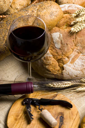 An assortment of breads with a glass of red wineの写真素材
