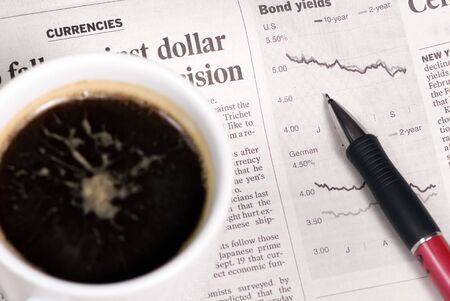 Looking at the morning paper and watching the markets drop.の写真素材