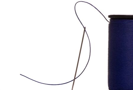 An isolated shot of a needle with blue thread. Preparing for a sewing job