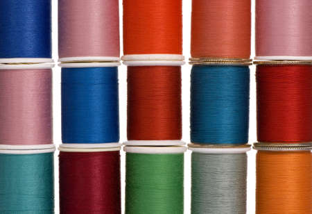 Different spools of thread create a colorful background