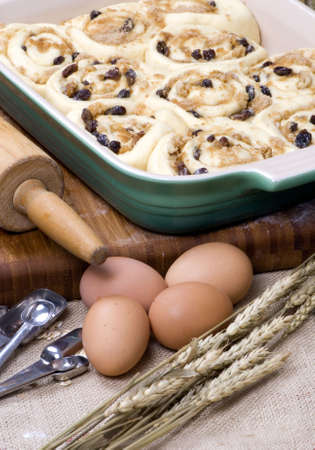 Making everybody's favorite... homemade cinnamon rolls with raisins and nuts. の写真素材