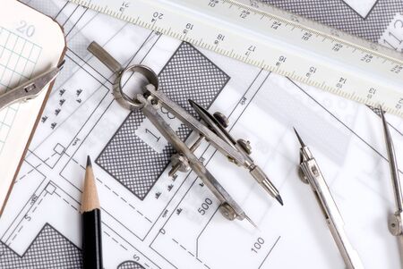 An engineer's work table with drawings and tools of the tradeの写真素材