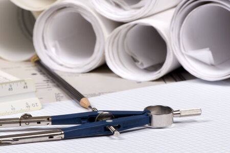 An engineer's work table with drawings and tools of the tradeの写真素材