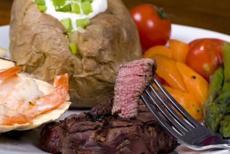 A mouth watering tenderloin steak with fresh vegetables and shrimpの写真素材