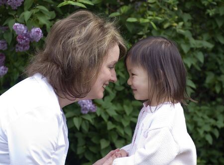 A mother and her adopted girl. Love affection bonding family