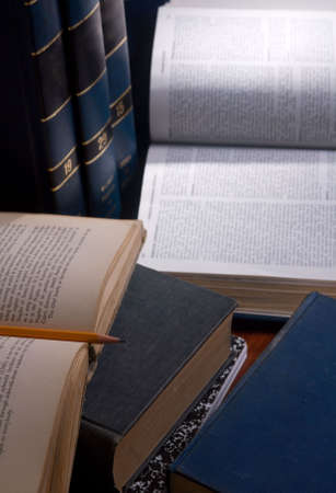 Books are open and someone is working hard on a research paper