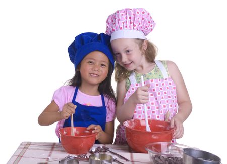 A young girl having fun in the kitchen making a mess....I mean making something special..... Education, learning, cooking, childhoodの写真素材