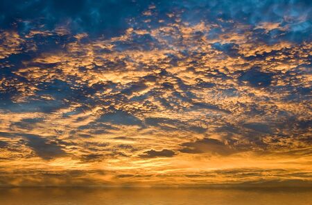 A colorful sunrise over misty waterの写真素材