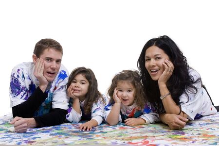 A young family having fun painting on the floorの写真素材
