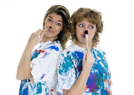 Two women having fun painting each otherの写真素材