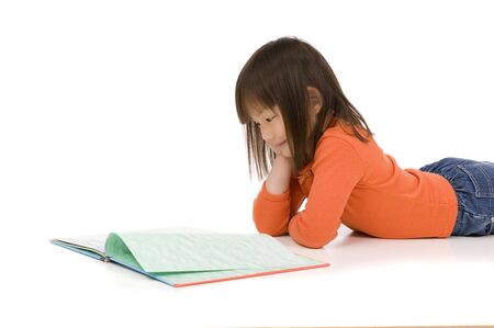 A young asian girl drawing a picture. On whiteの写真素材