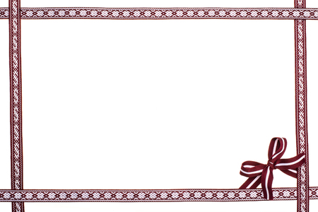 Border frame of dark red national latvian ribbons isolated on white backgroundの写真素材